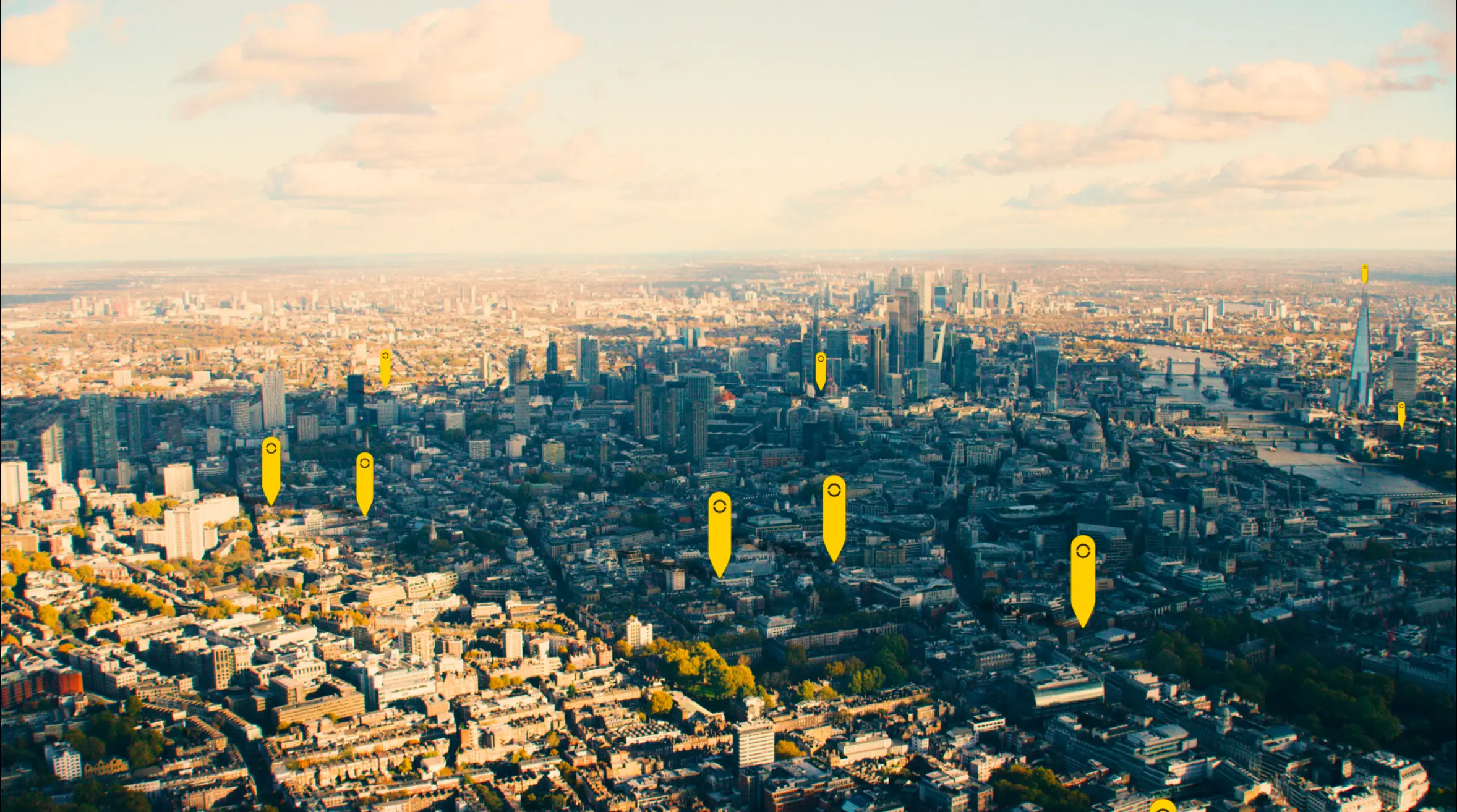 Aerial view across London with yellow location pins marking Fora's buildings
